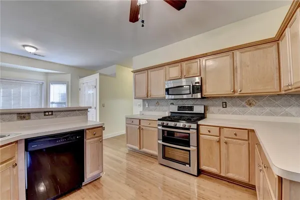 a kitchen with stainless steel appliances granite countertop a stove and a sink