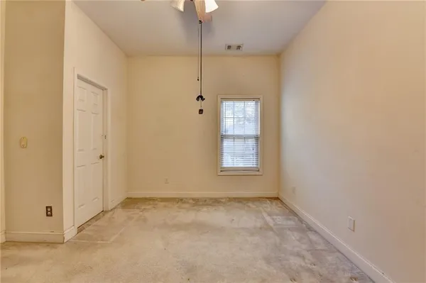 an empty room with windows and cabinet