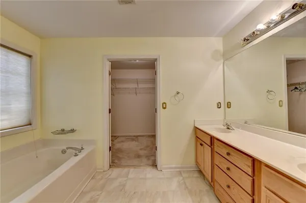 a spacious bathroom with a granite countertop sink a toilet and shower