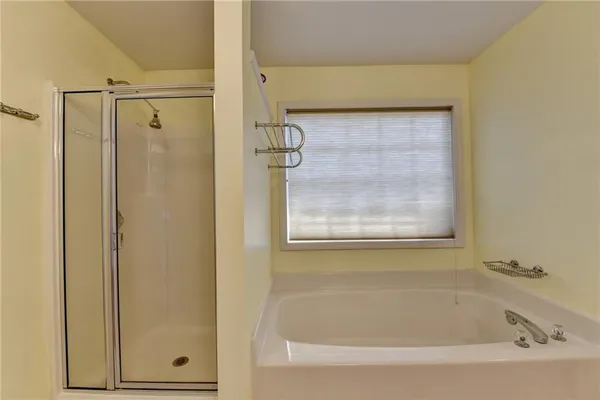 a bathroom with a shower and a bathtub