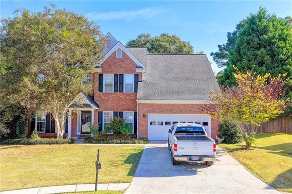 a front view of a house with a garden