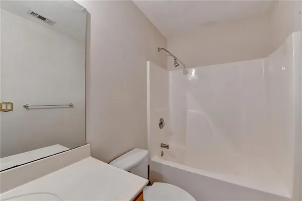 a bathroom with a toilet and shower
