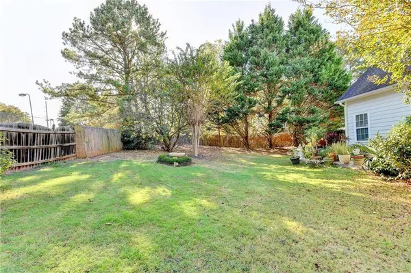 a view of a backyard with a garden and entertaining space