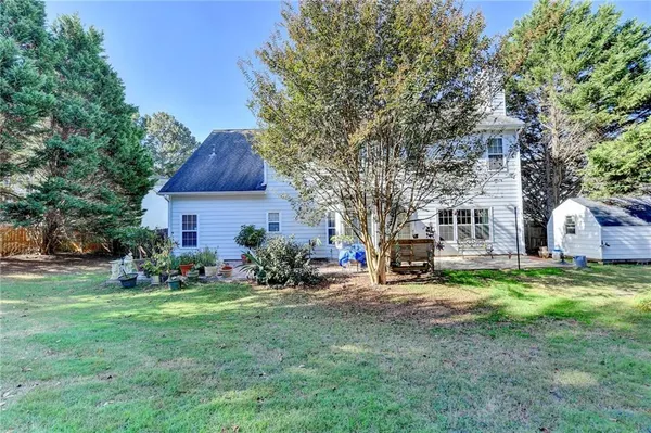 a backyard of a house with table and chairs