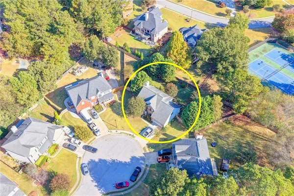 aerial view of a house with swimming pool and large trees