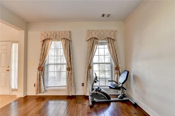a view of room with wooden floor and windows