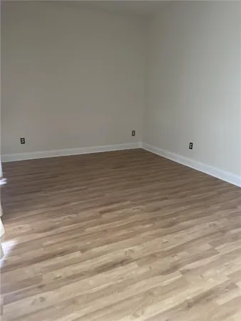 a view of a livingroom with wooden floor and staircase