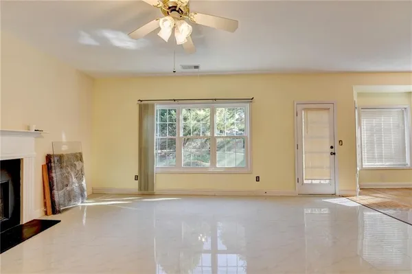 a view of a livingroom with an empty space and a window