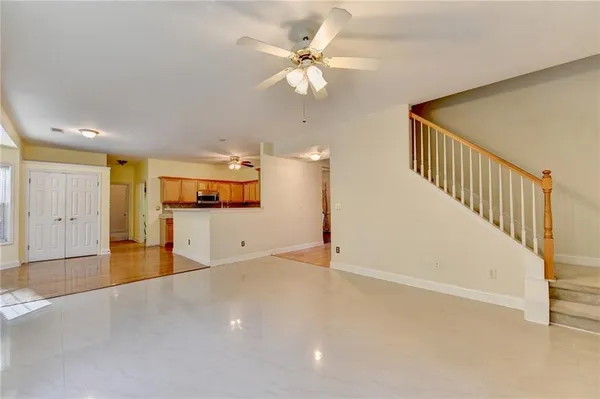 an empty room with a white walls and ceiling fan
