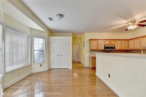 a view of a living room hardwood floor and a ceiling fan