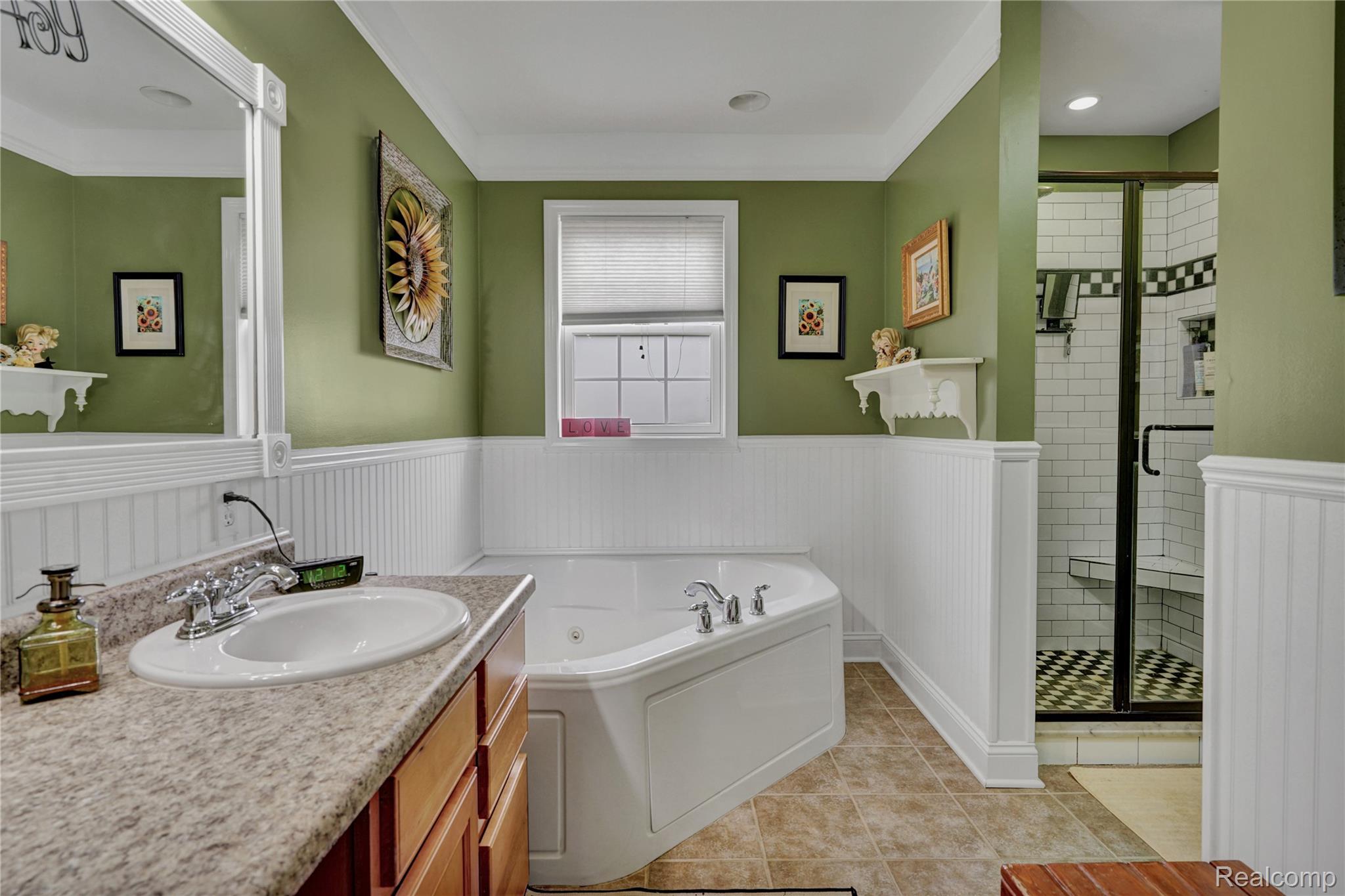 3690 Brauer Road Oxford, MI 48371 - Photo 26 of 63 Full bath featuring vanity, a bath, a stall shower, wainscoting, and light tile patterned flooring