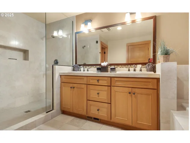 a bathroom with a sink shower and a mirror