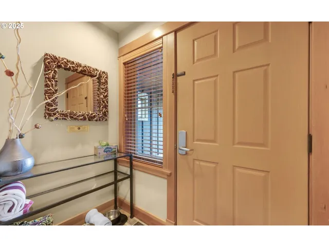 a view of a hallway with two couches and a painting on the wall
