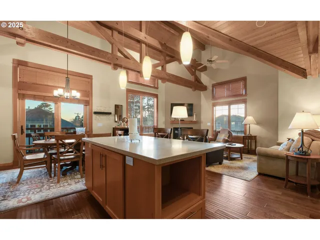 a open kitchen with cabinets a sink appliances and a dining table