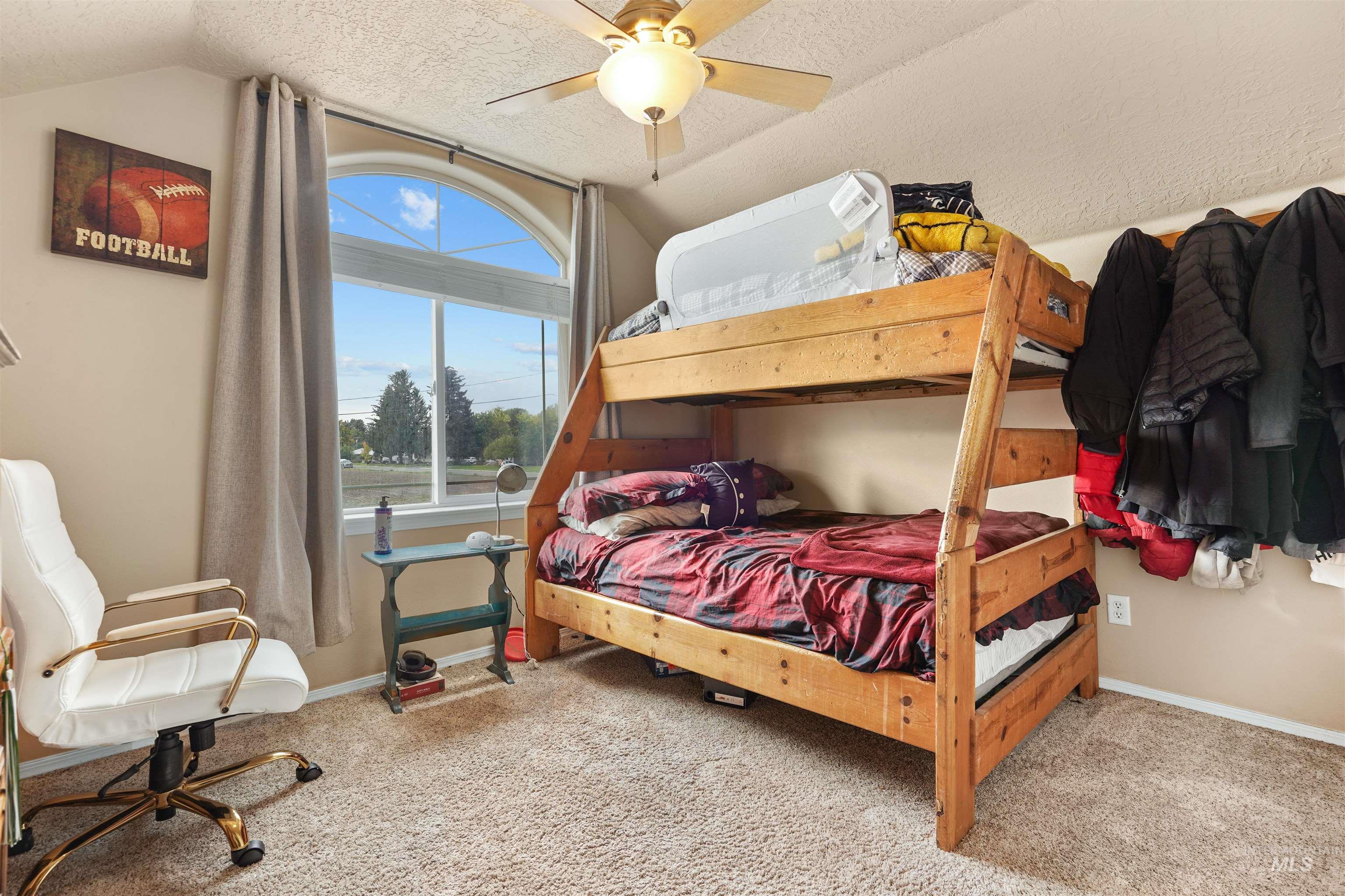 500 East 19th Street Burley, ID 83318 - Photo 16 of 31 Bedroom featuring vaulted ceiling, light carpet, a textured ceiling, and ceiling fan