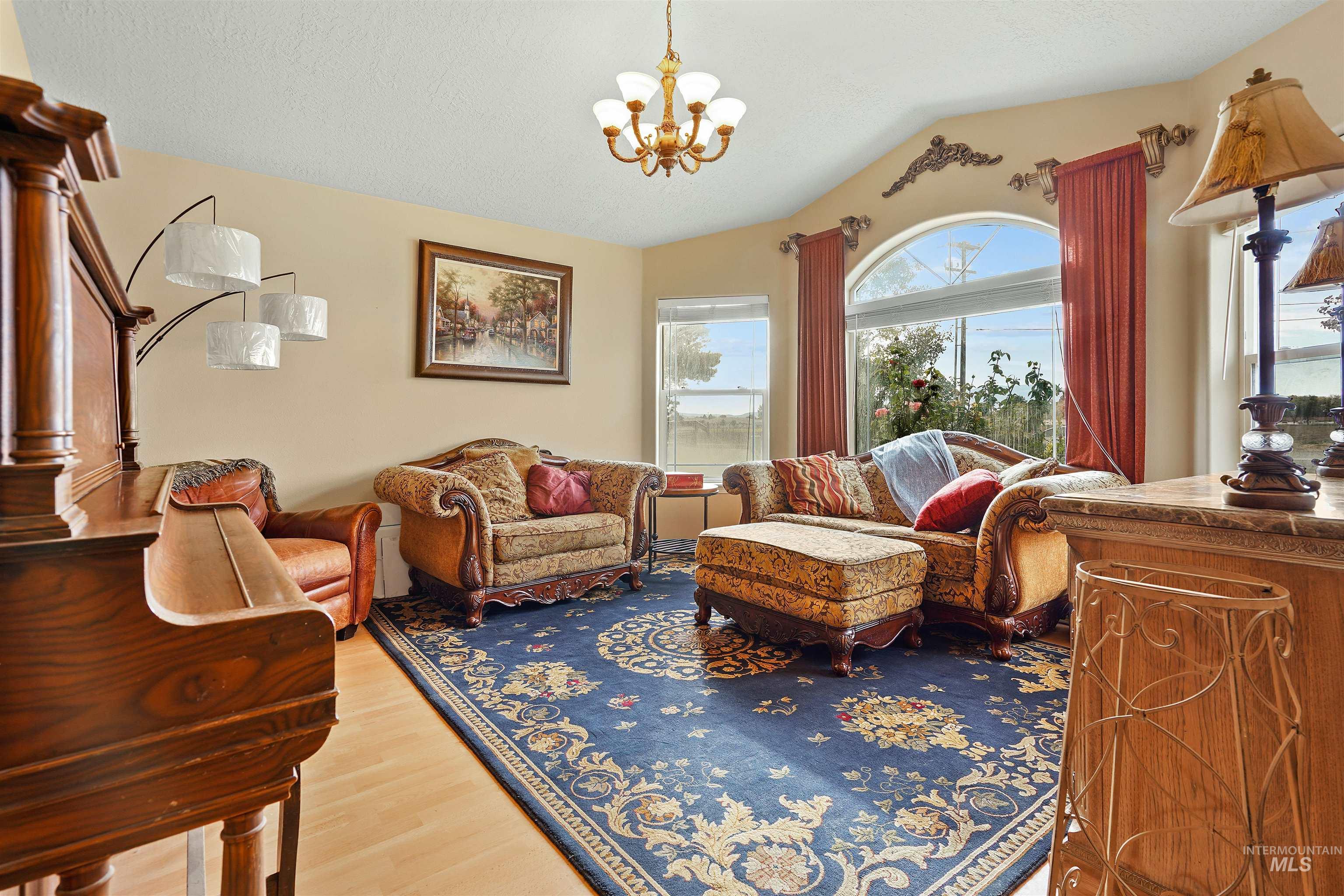 500 East 19th Street Burley, ID 83318 - Photo 9 of 31 Sitting room with vaulted ceiling, a chandelier, and light wood-style floors