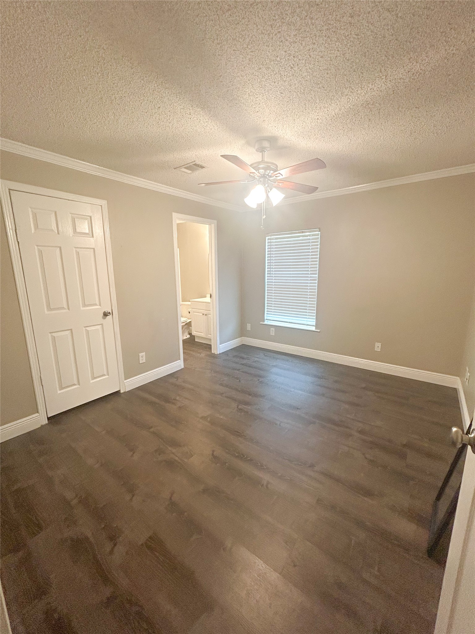 113 Varsity Circle Huntsville, TX 77340 - Photo 11 of 16 an empty room with wooden floor and windows
