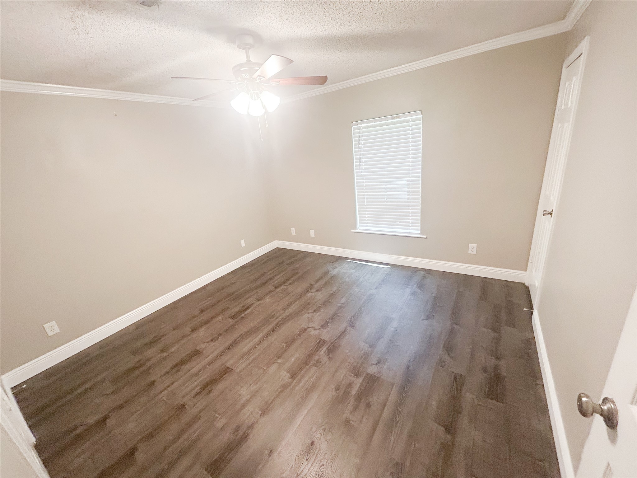 113 Varsity Circle Huntsville, TX 77340 - Photo 13 of 16 a view of an empty room with wooden floor and a window