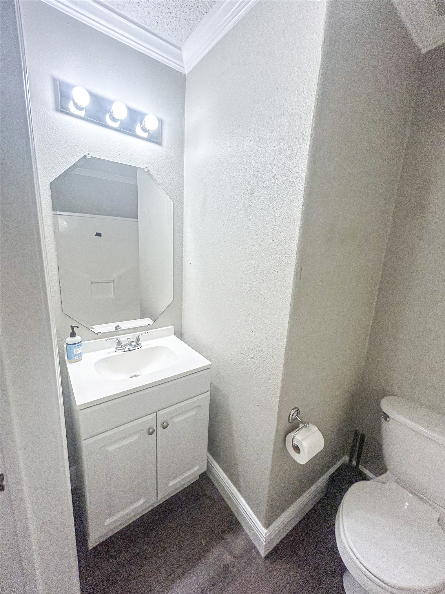 113 Varsity Circle Huntsville, TX 77340 - Photo 15 of 16 a bathroom with a toilet a sink and mirror