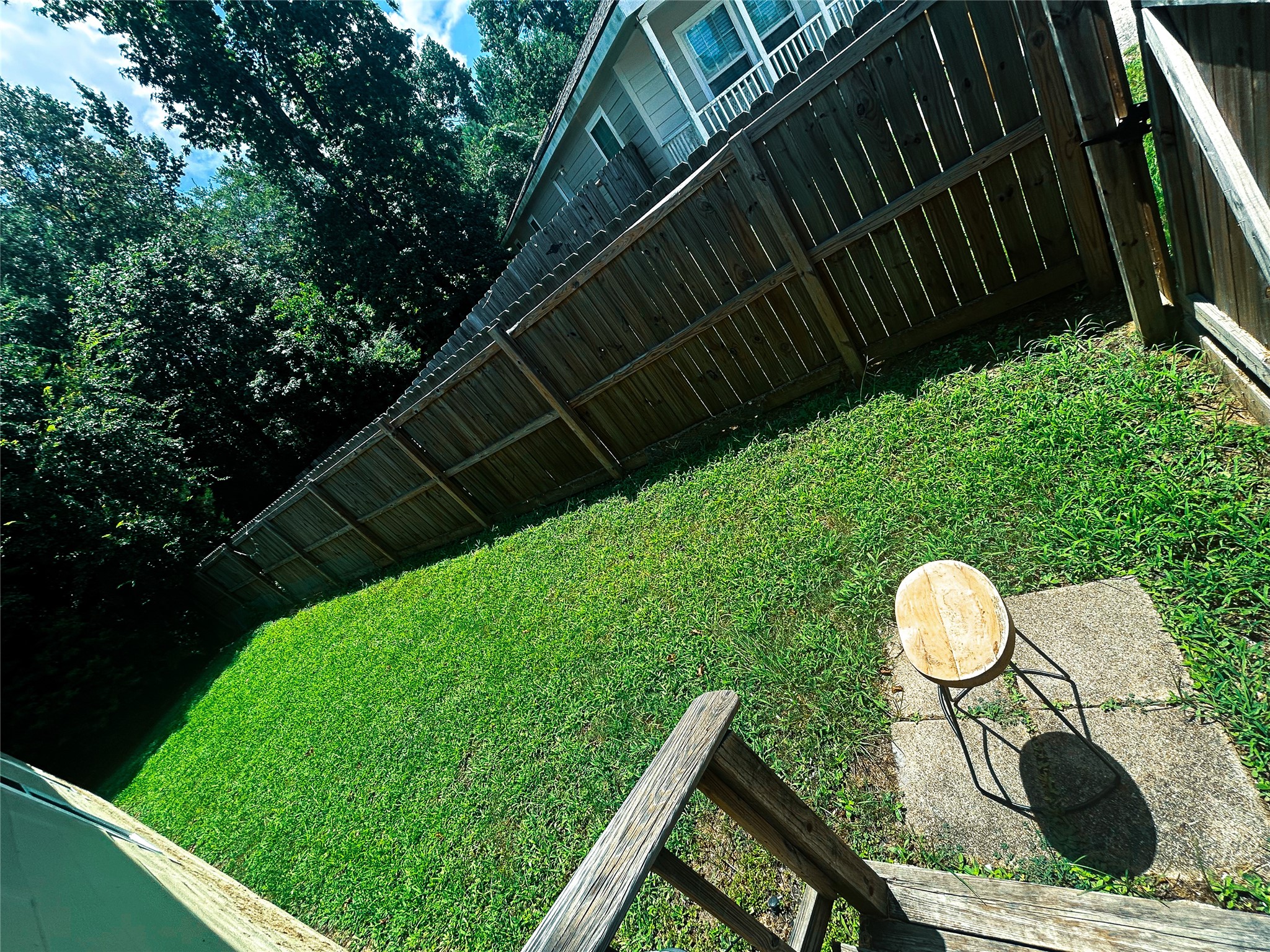 113 Varsity Circle Huntsville, TX 77340 - Photo 16 of 16 a backyard of a house with a garden and plants