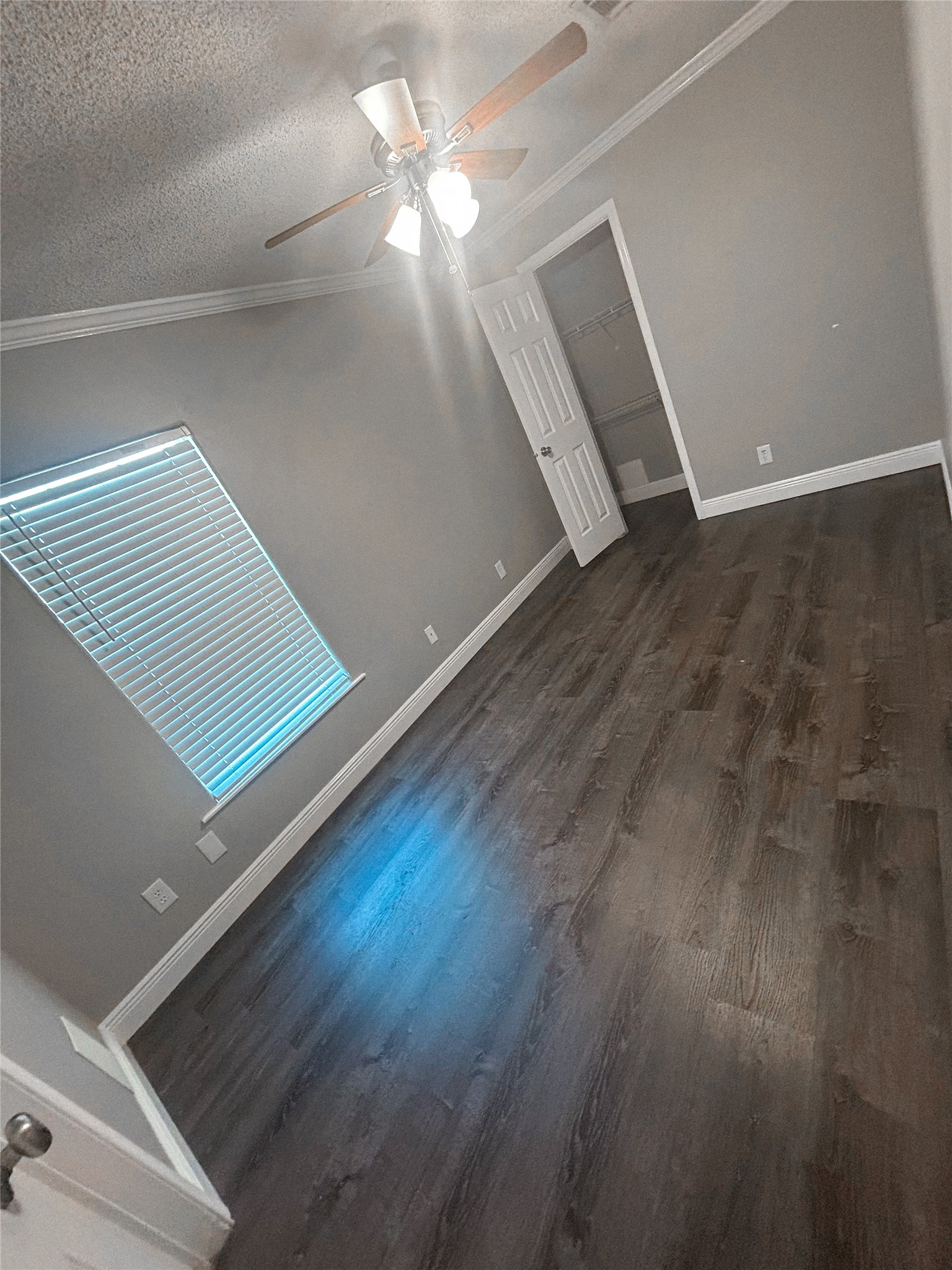 113 Varsity Circle Huntsville, TX 77340 - Photo 7 of 16 an empty room with wooden floor and chandelier fan