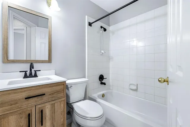 a bathroom with a sink toilet vanity and shower
