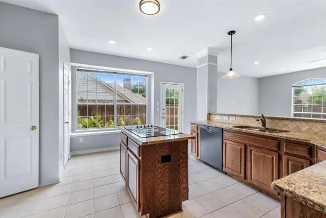 a kitchen with stainless steel appliances granite countertop a sink and a stove