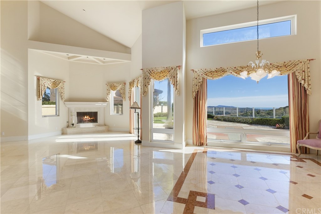 2 Crystal View Ridge Laguna Niguel, CA 92677 - Photo 17 of 50 a view of a living room with fireplace furniture and a floor to ceiling window