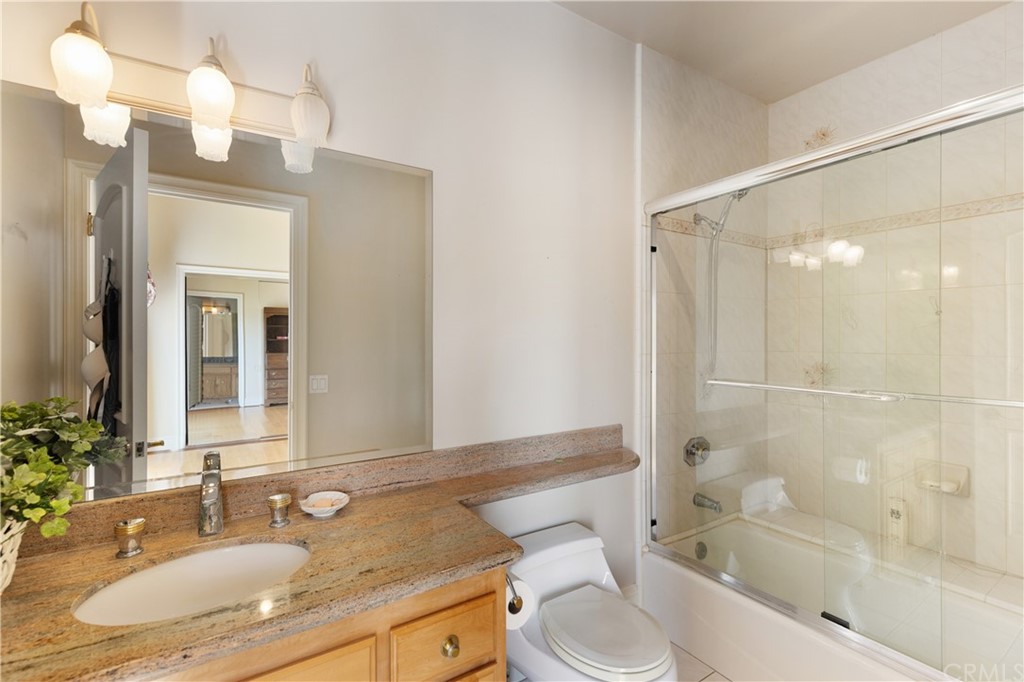 2 Crystal View Ridge Laguna Niguel, CA 92677 - Photo 36 of 50 a bathroom with a granite countertop sink toilet mirror and shower