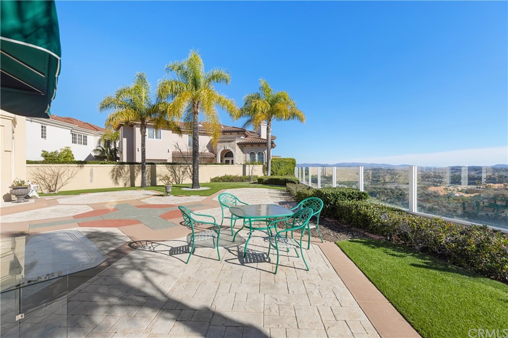 2 Crystal View Ridge Laguna Niguel, CA 92677 - Photo 43 of 50 a view of a patio with table and chairs potted plants with wooden floor