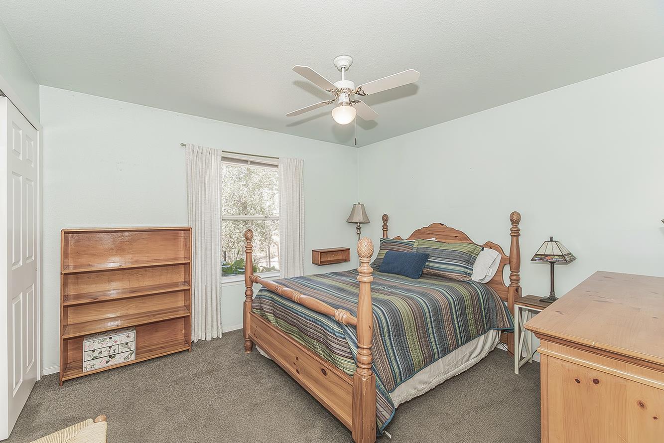 14815 Garlock Lane Prather, CA 93651 - Photo 27 of 80 a bedroom with a bed and a ceiling fan