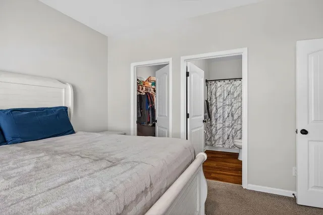 a bathroom with a granite countertop sink toilet and a mirror