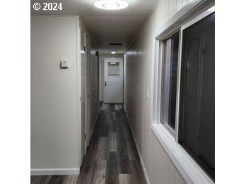 1125 58th Street, Unit 35 Springfield, OR 97478 - Photo 7 of 15 a view of a hallway with wooden floor and staircase