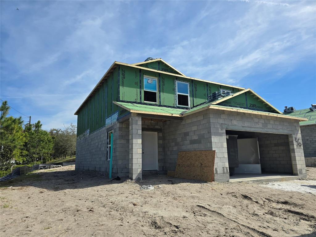 1701 Andover Rdg Drive DeLand, FL 32720 - Photo 3 of 14 a front view of a house with a yard and garage