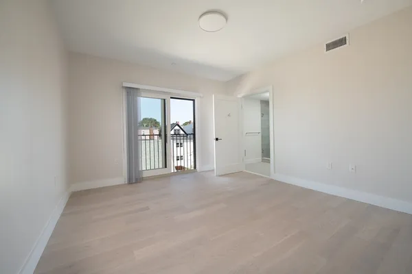 an empty room with windows and closet