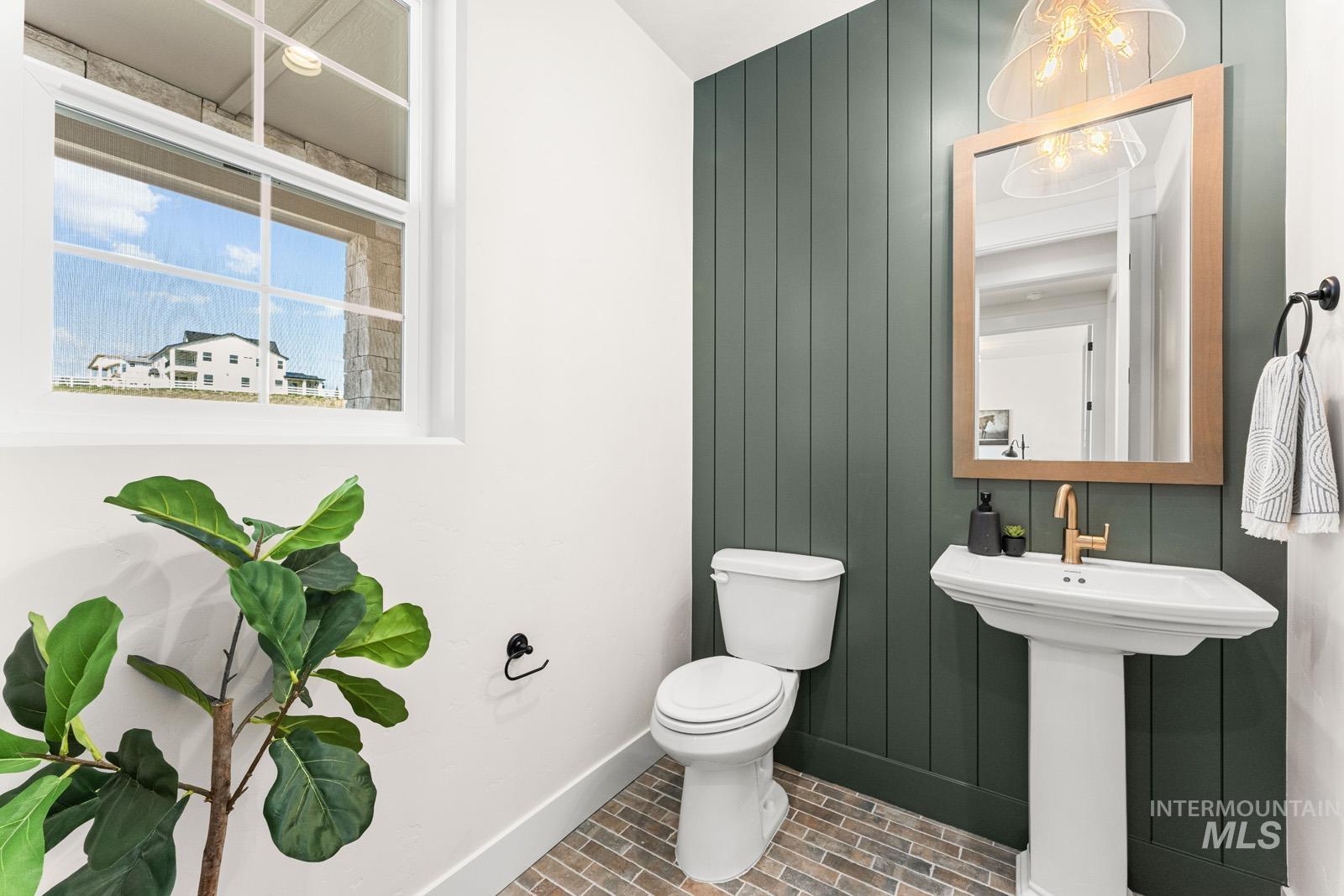 13344 North Spring Creek Way Boise, ID 83714 - Photo 12 of 39 Half bath with brick patterned flooring and wood walls