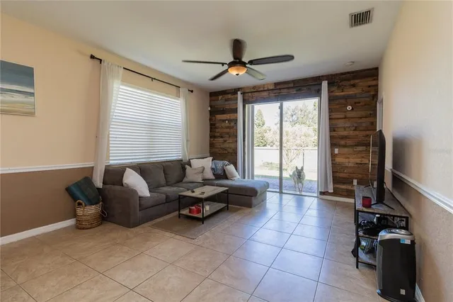 a living room with furniture and a large window