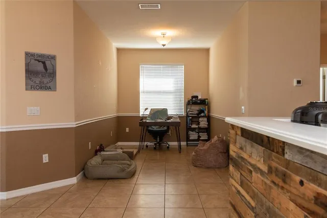 a kitchen with a sink and chairs