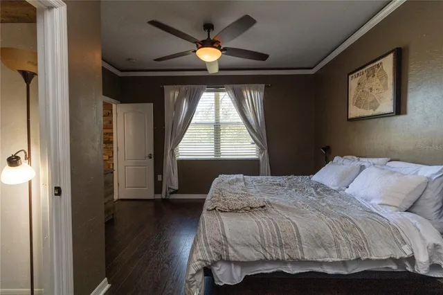 a bedroom with a bed and a large window