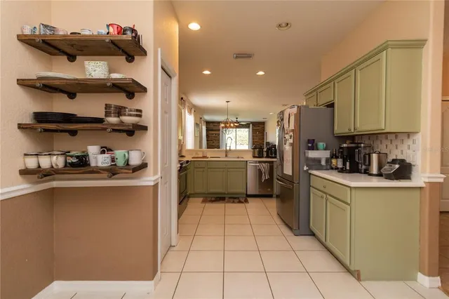 a kitchen with cabinets a sink and appliances