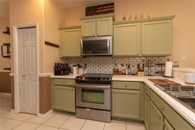 a kitchen with a stove microwave and sink