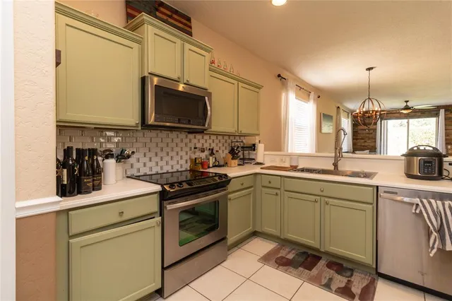 a kitchen with stainless steel appliances granite countertop a sink stove and microwave
