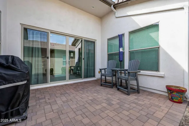 a view of a two chairs in a patio