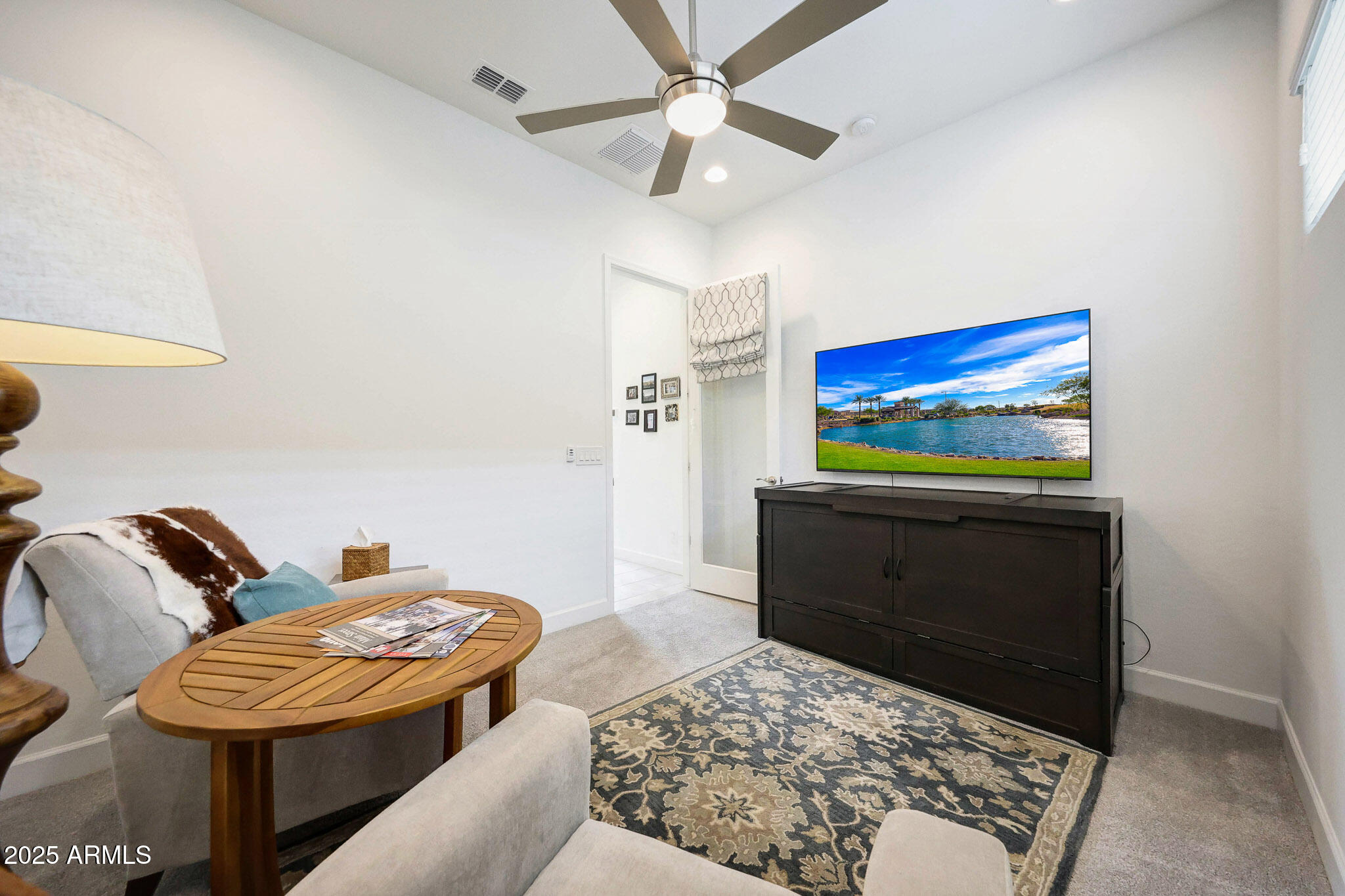 20771 West Colter Street Buckeye, AZ 85396 - Photo 19 of 44 a living room with furniture and a flat screen tv