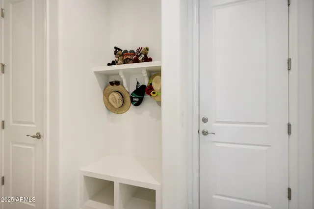 a view of a patio with a table and chairs under an umbrella