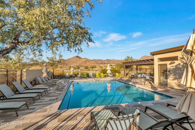 a view of a patio with a table chairs and backyard
