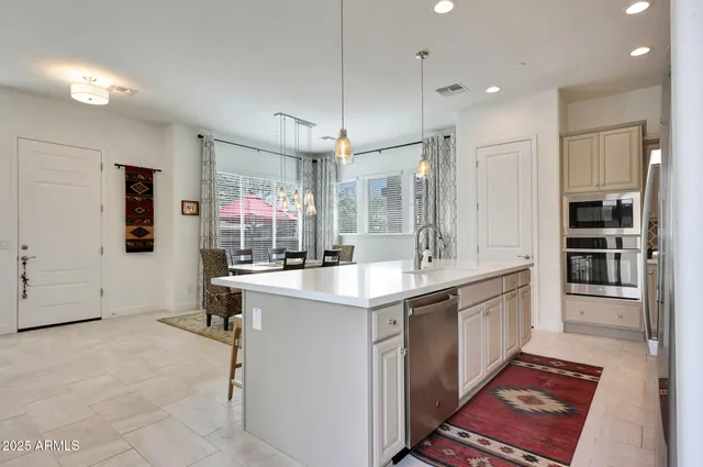 a kitchen with kitchen island cabinets and refrigerator