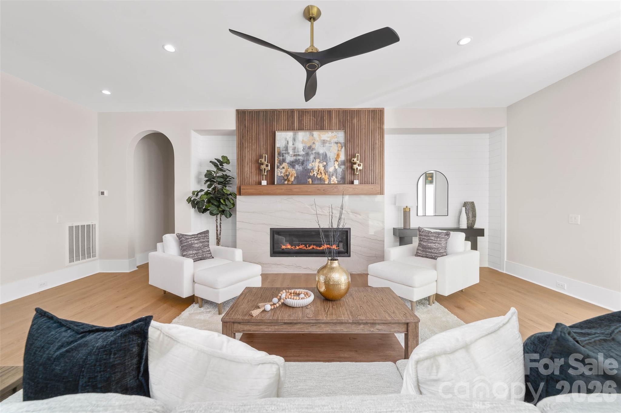 216 Walnut Street Davidson, NC 28036 - Photo 11 of 48 a living room with furniture a fireplace and a chandelier