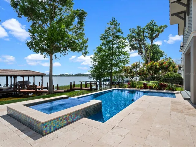 a living room with furniture fireplace and a large window