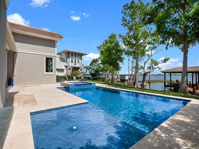 a living room with furniture kitchen view and a large window
